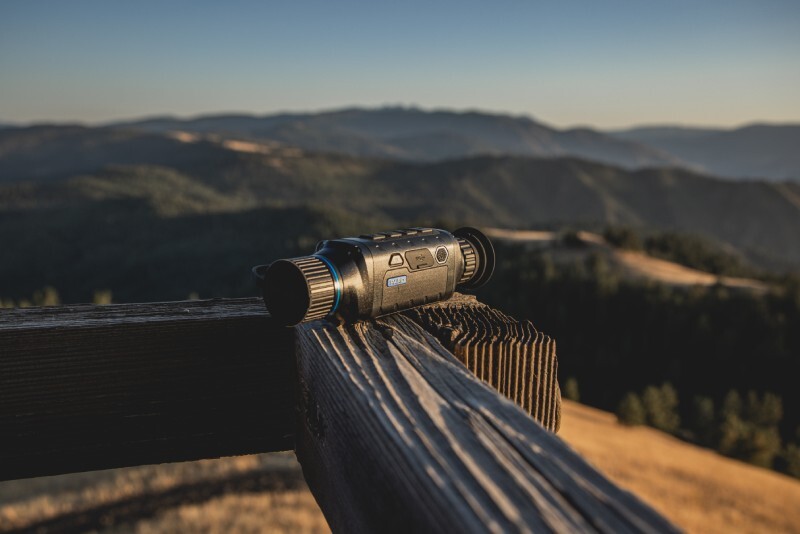 PARD Thermal Optic side view with a country background.