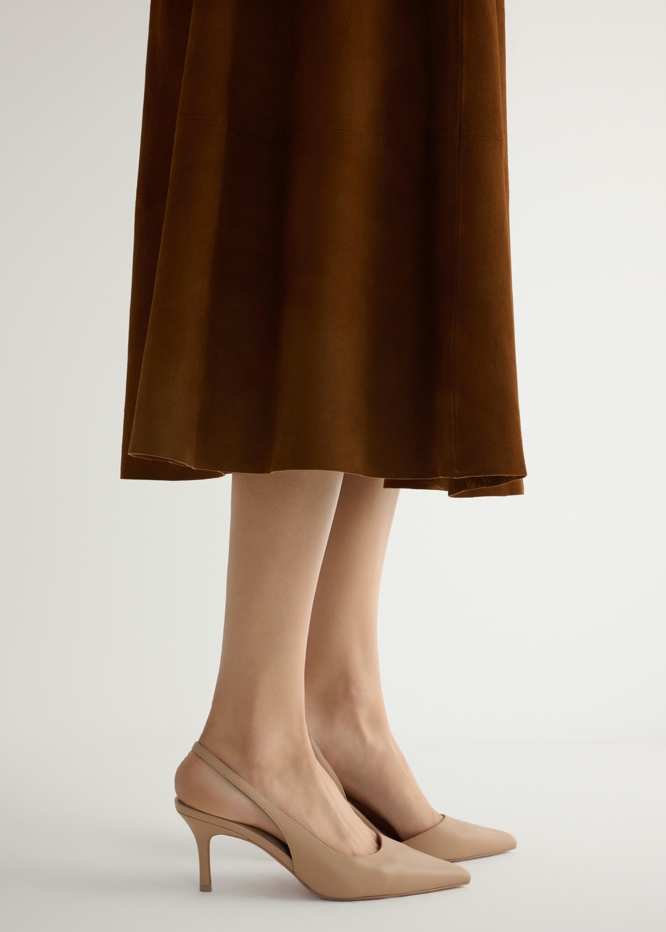 Beige leather pumps with a cut-out heel