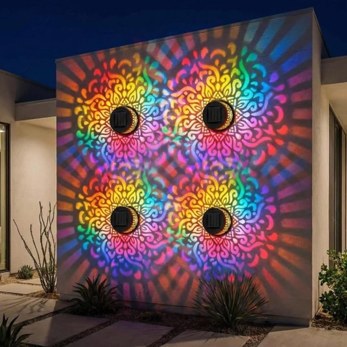 Four colorful solar mandala lights projecting patterns on an outdoor wall
