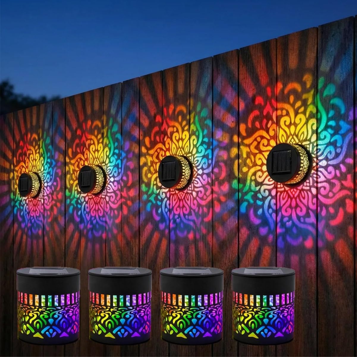 Four seven-color solar mandala lights projecting colorful patterns across an outdoor fence