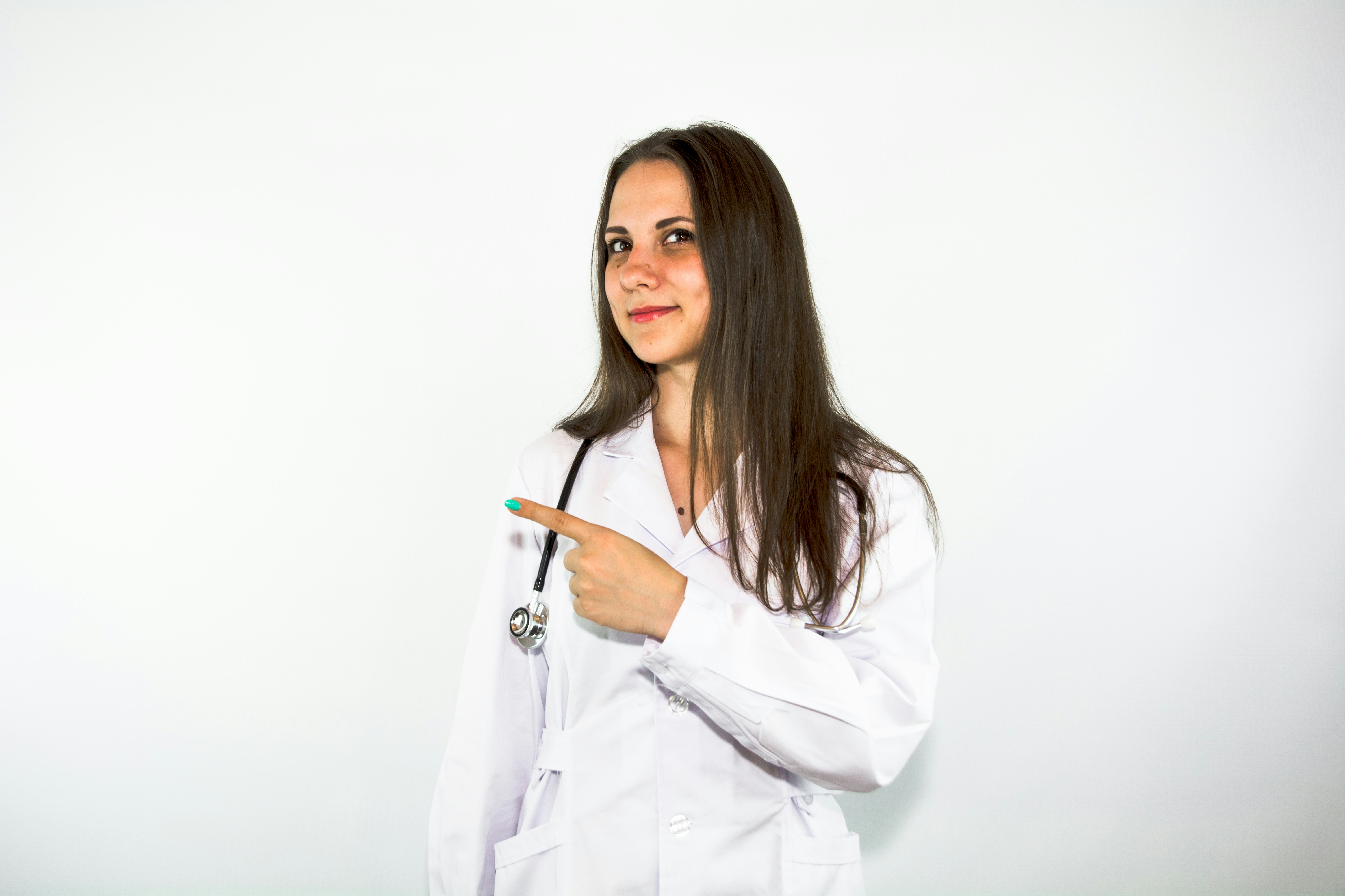 Female doctor in a white coat pointing toward the featured product