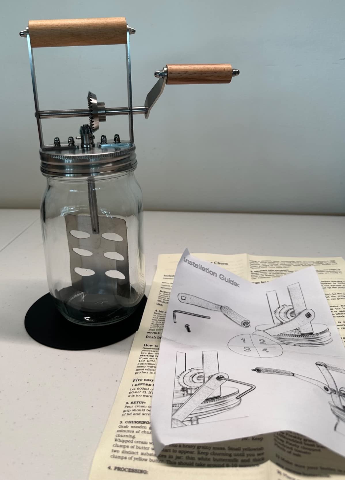 Thick glass, wood handle, all metal parts, great for the kids to learn.