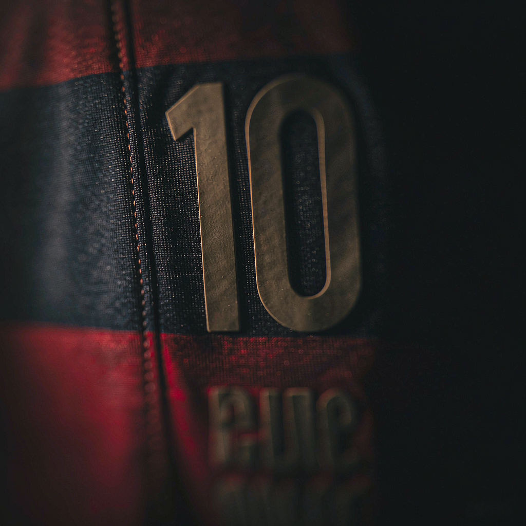 Close-up of the number 10 and name set printed on a striped football shirt