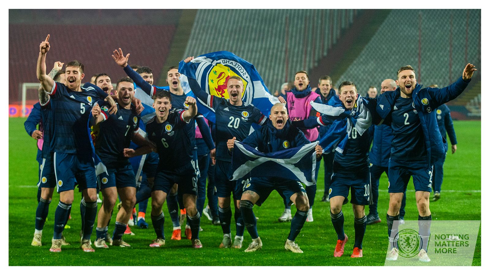 Scotland national team players celebrate with flags after victory