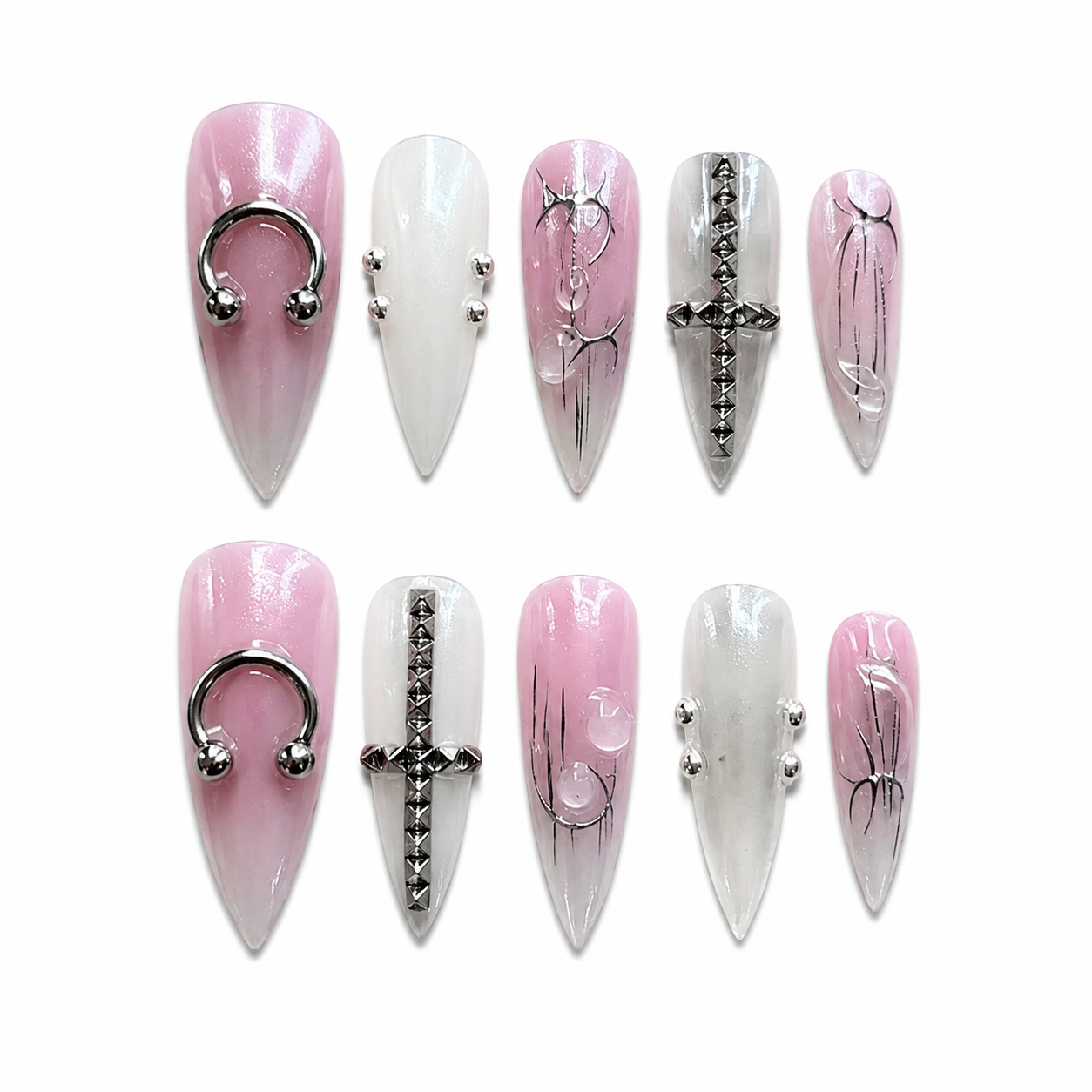 Glossy pink and white iridescent chrome stiletto press-on nails with silver horseshoe piercing rings, metallic crosses, and 3D droplets.
