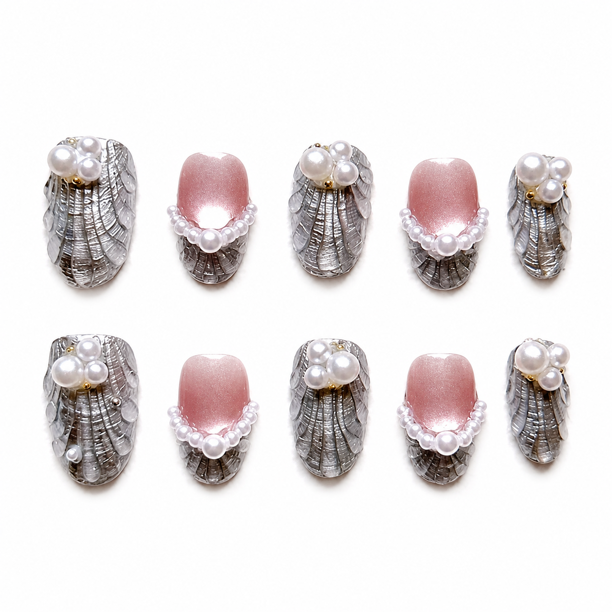 Glossy press-on nails featuring 3D carved silver seashell textures and pearlescent pink bases adorned with neat pearl arches and clusters.