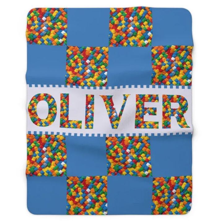 Gepersonaliseerde plaid met bouwblokken en naam, decoratieve deken voor op de bank of bank met bouwstenenmotief.