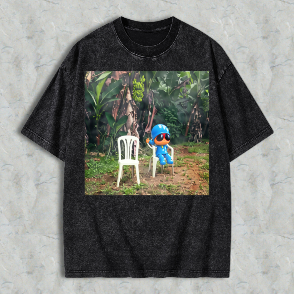 Blue Cartoon Character Sitting On White Plastic Chair In Jungle Washed T-shirt