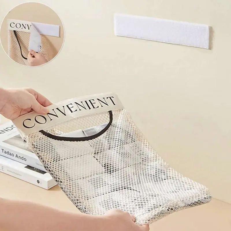 Adhesive mounting strip for wall mounted trash bag holder