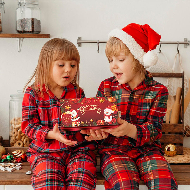 Children holding Christmas money gift envelope