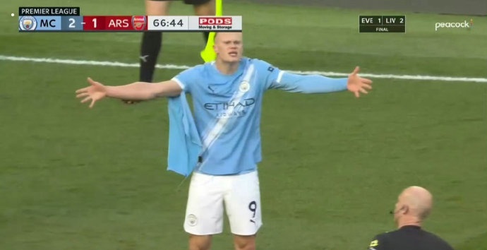 Haaland showing his torn jersey