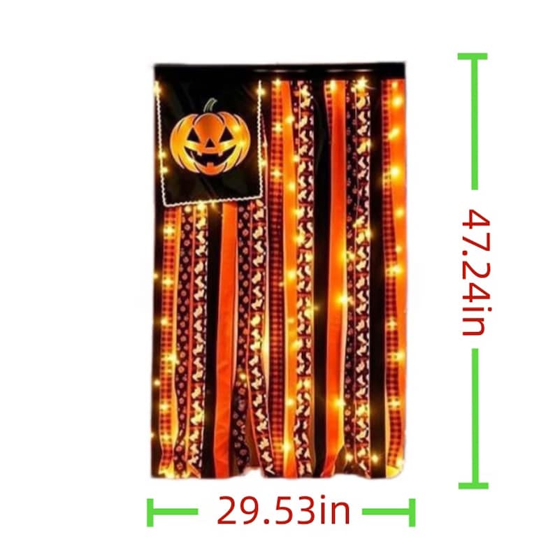 May include: A Halloween-themed ribbon wall hanging featuring a black fabric square with a jack-o'-lantern graphic, adorned with vertical orange, black, and patterned ribbons and string lights. It measures 120 cm high by 75 cm wide.