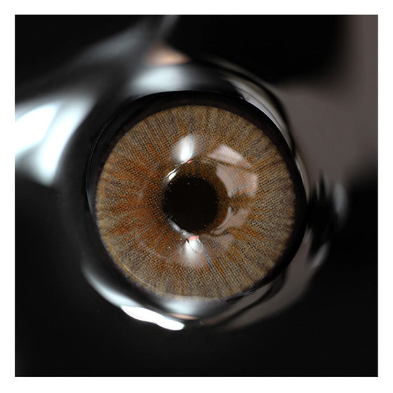 Close up of silicone hydrogel Uris Arctic Brown contact lenses in handpainted design