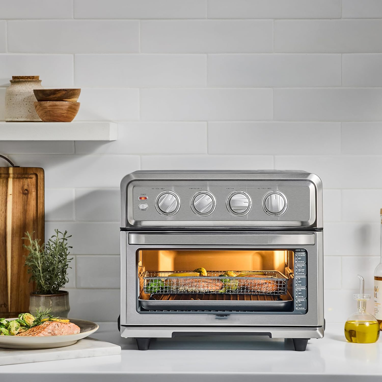 Air fryer oven with 8 functions: air frying, convection, grilling, and keep warm.