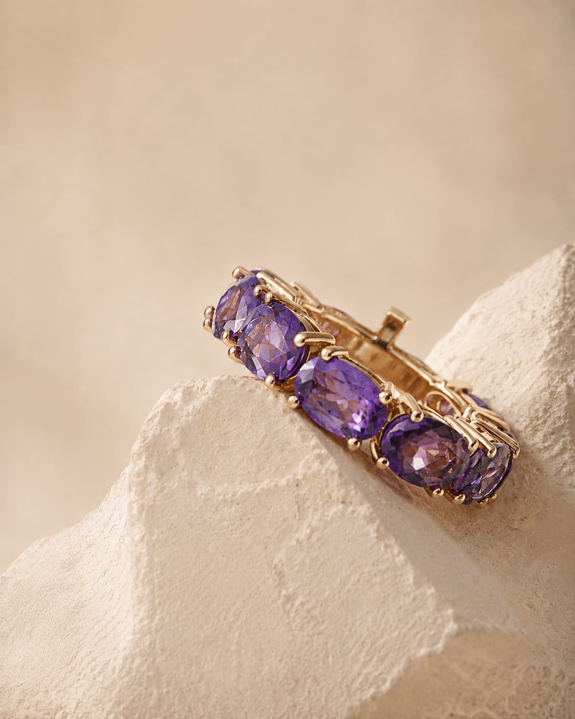XAX amethyst eternity ring on travertine stone