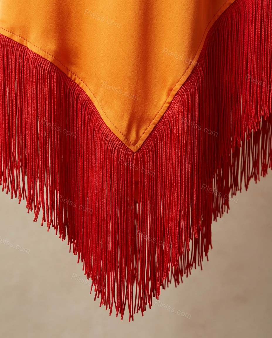 Red Maxi Cape One-Shoulder Dress, close-up of fringe trim, one-shoulder neckline and cape sleeve, by Rieiss