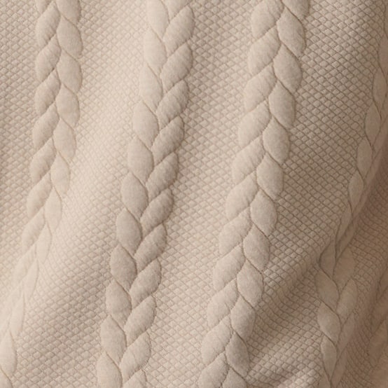 Close-up of the beige sweater textured pattern