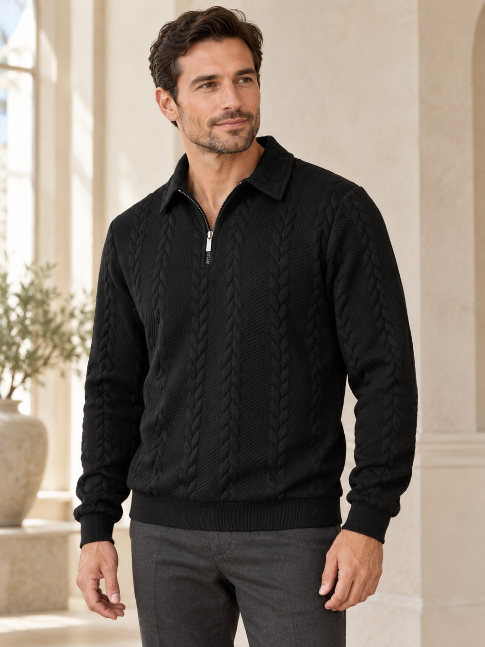 Man wearing the black textured quarter-zip sweater with the full collar, cuffs and lower hem visible