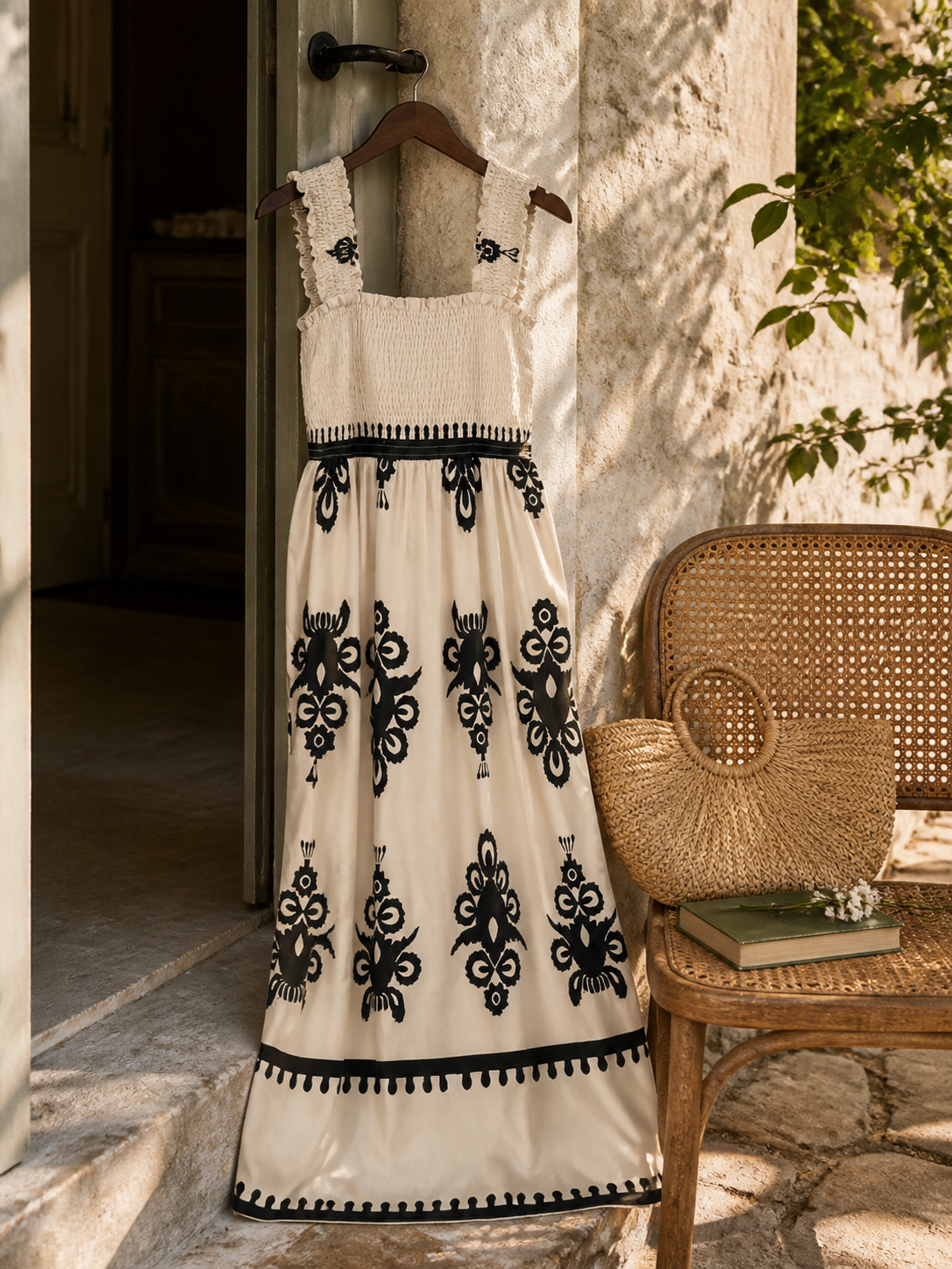 Cream and black printed dress arranged for a quiet summer courtyard outing