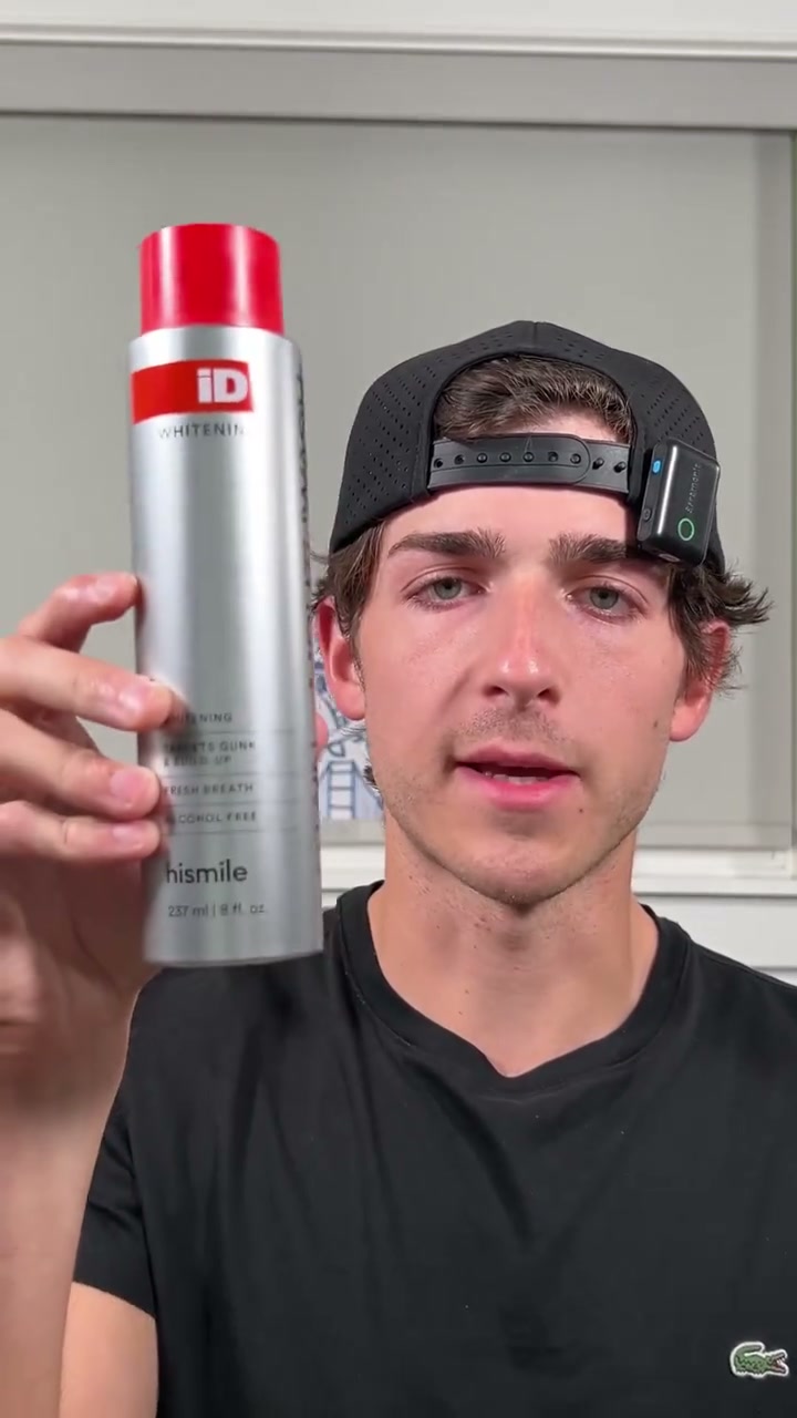 Demonstrator holding iD Stain Whitening Mouthwash