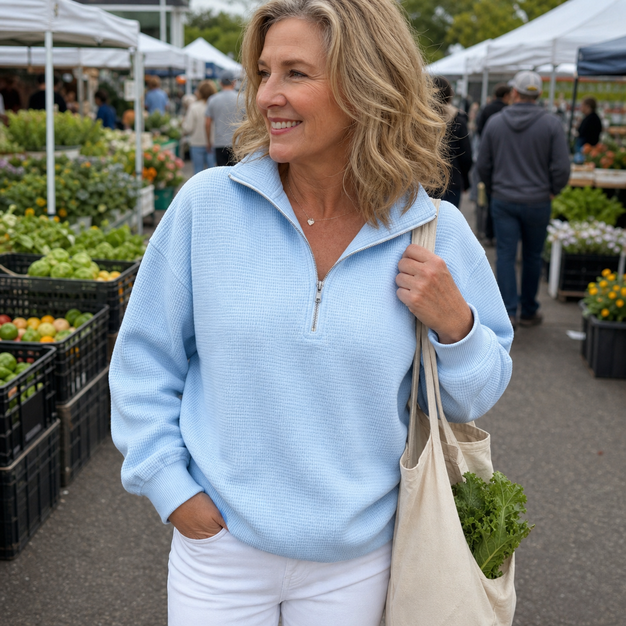 Woman wearing blue waffle quarter zip at a market