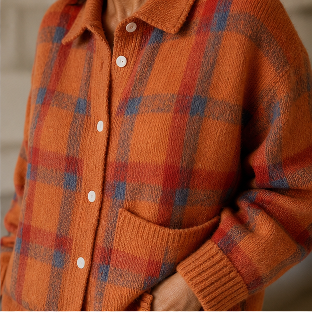 Close view of the plaid knit, white buttons and pocket