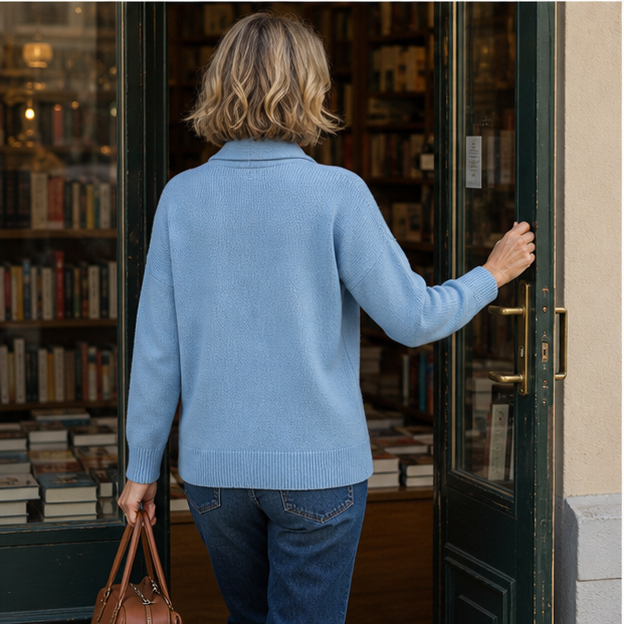 Powder blue sweater styled with jeans at a bookstore