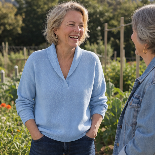 Woman wearing the blue pullover in a community garden