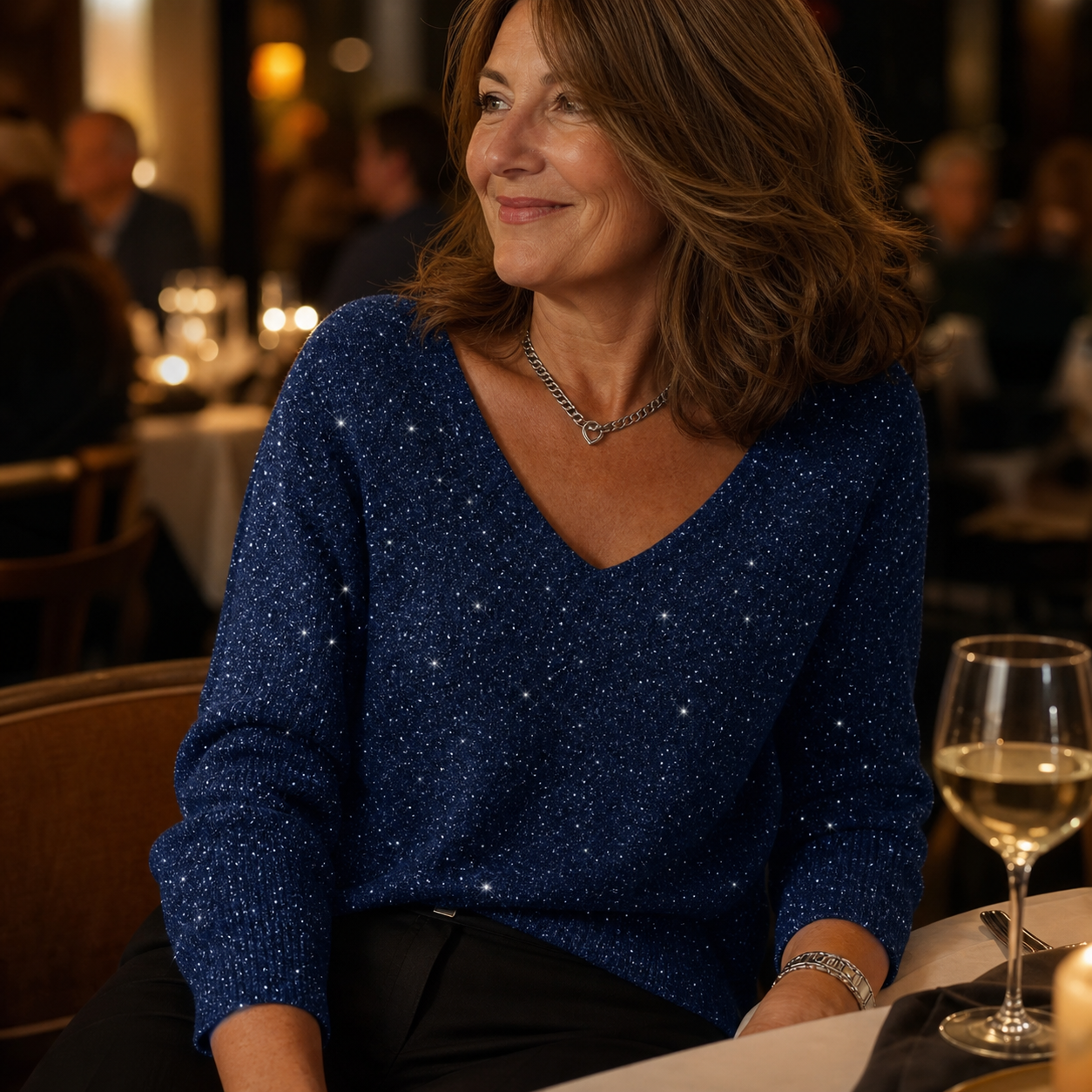 Red sparkling V-neck knit top styled for a restaurant dinner