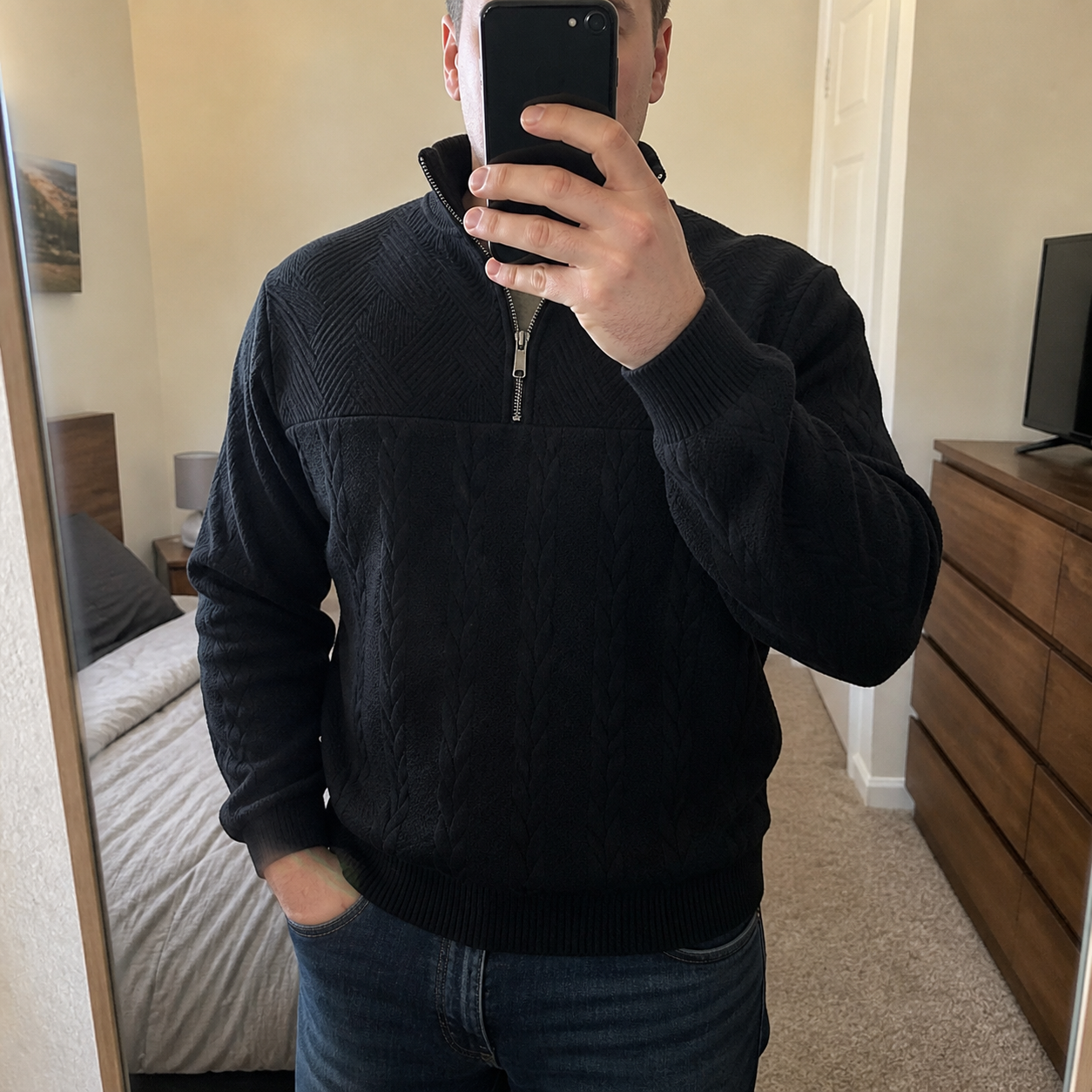 Customer style photo showing the black cable-knit quarter-zip sweater