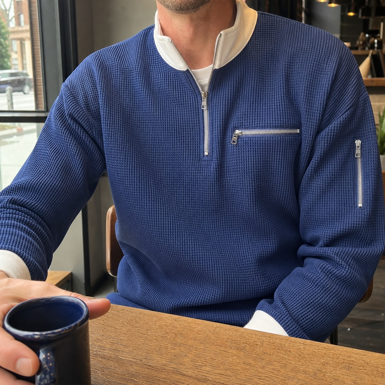 Customer cafe photo in the Navy Blue waffle half-zip pullover with White collar and zip details