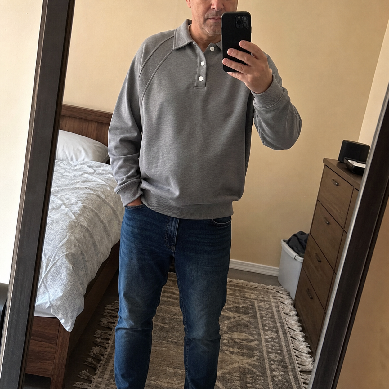 Customer mirror selfie in gray pullover