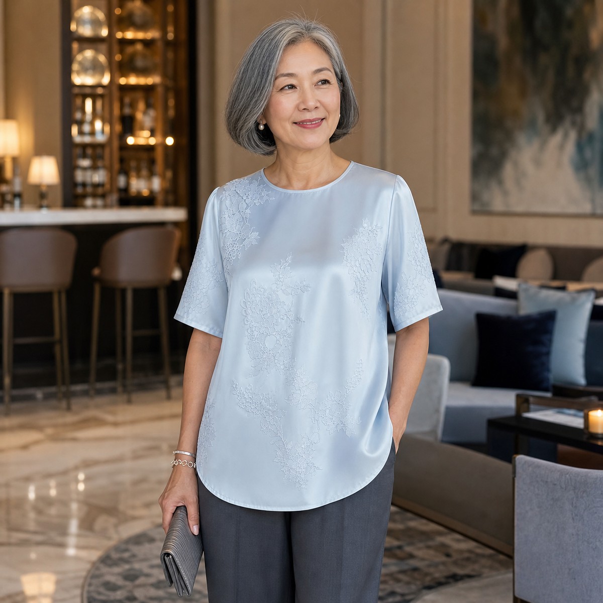 1tu0803002 woman wearing the light blue floral blouse in a hotel lounge