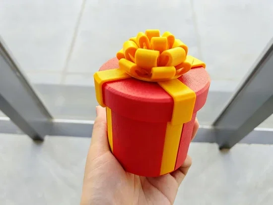 Tiffany holding a red and gold prank money box