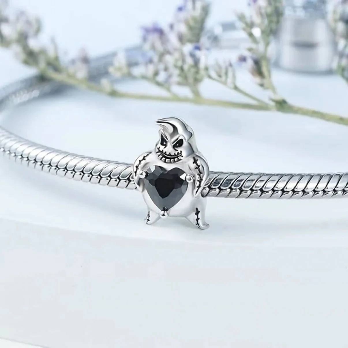 Gothic character charm on bracelet