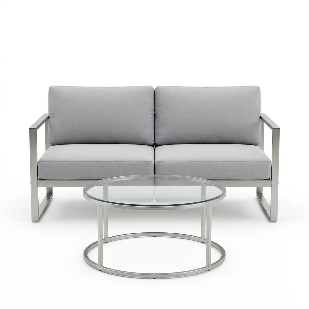 Divano in acciaio inox e tavolino in vetro temperato