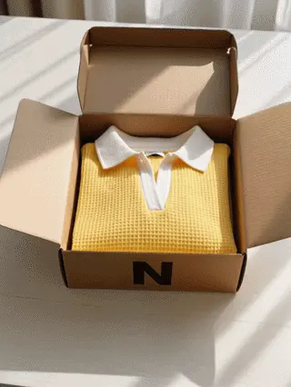 Women's waffle pullover folded inside a delivery box