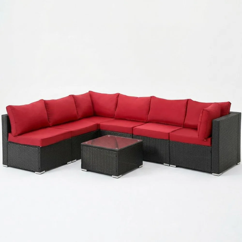 Divano angolare modulare in rattan con cuscini rossi
