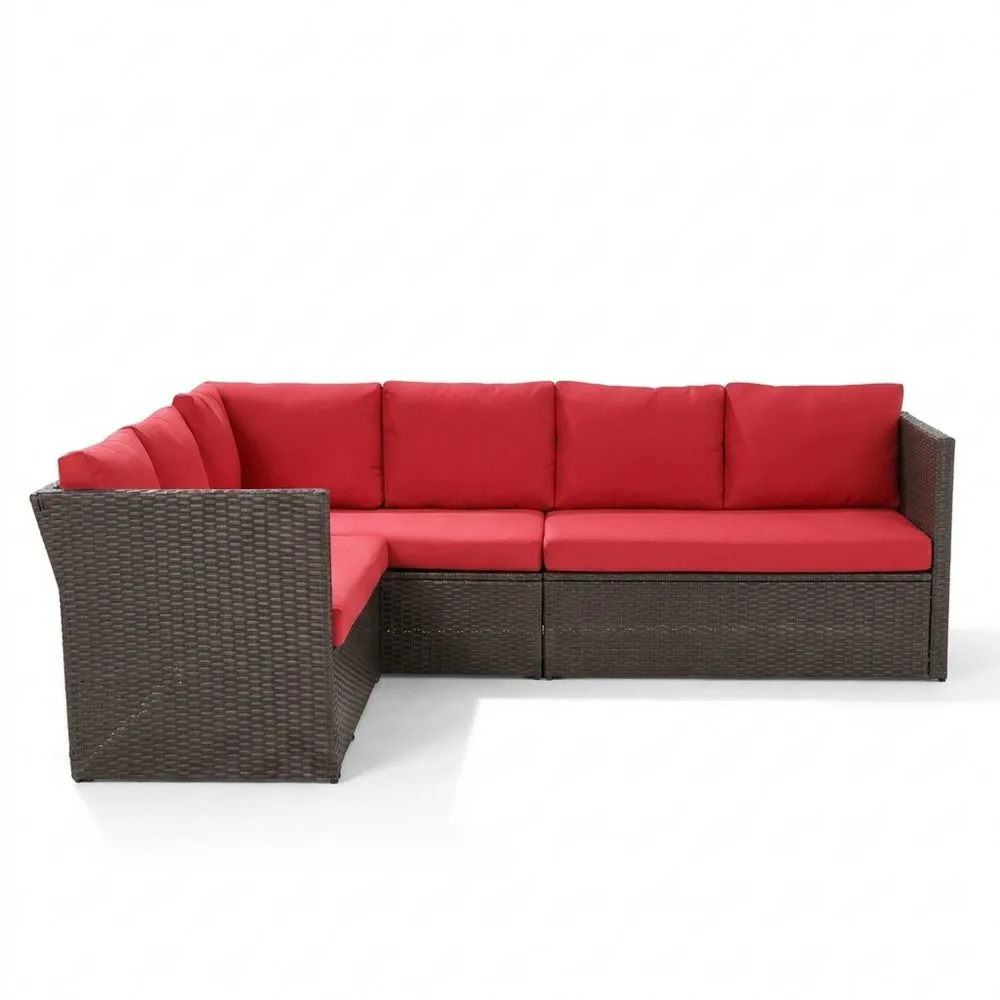 Divano angolare in rattan sintetico con cuscini rossi
