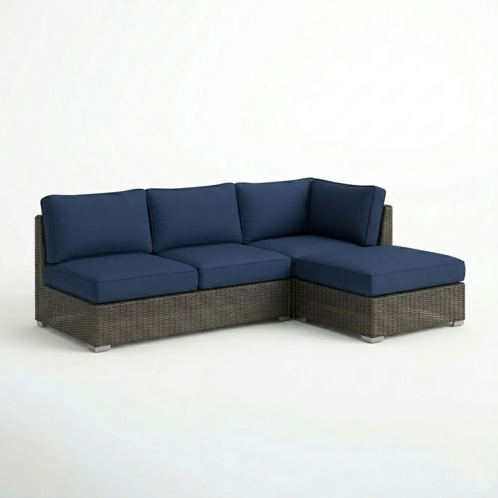 Garten-Ecksofa aus Rattan mit blauen Sitz- und Rückenkissen