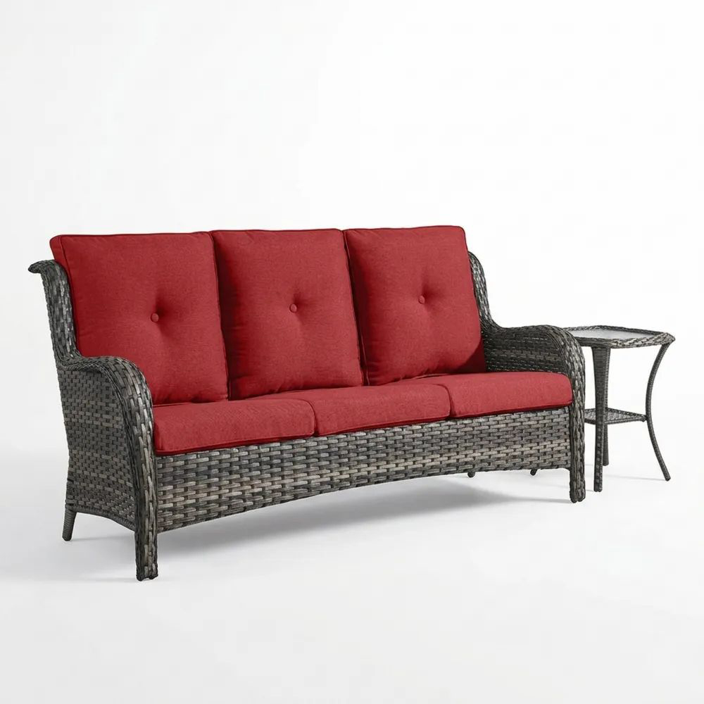 Sofá de ratán con cojines rojos y mesa auxiliar-Casaluxeeu