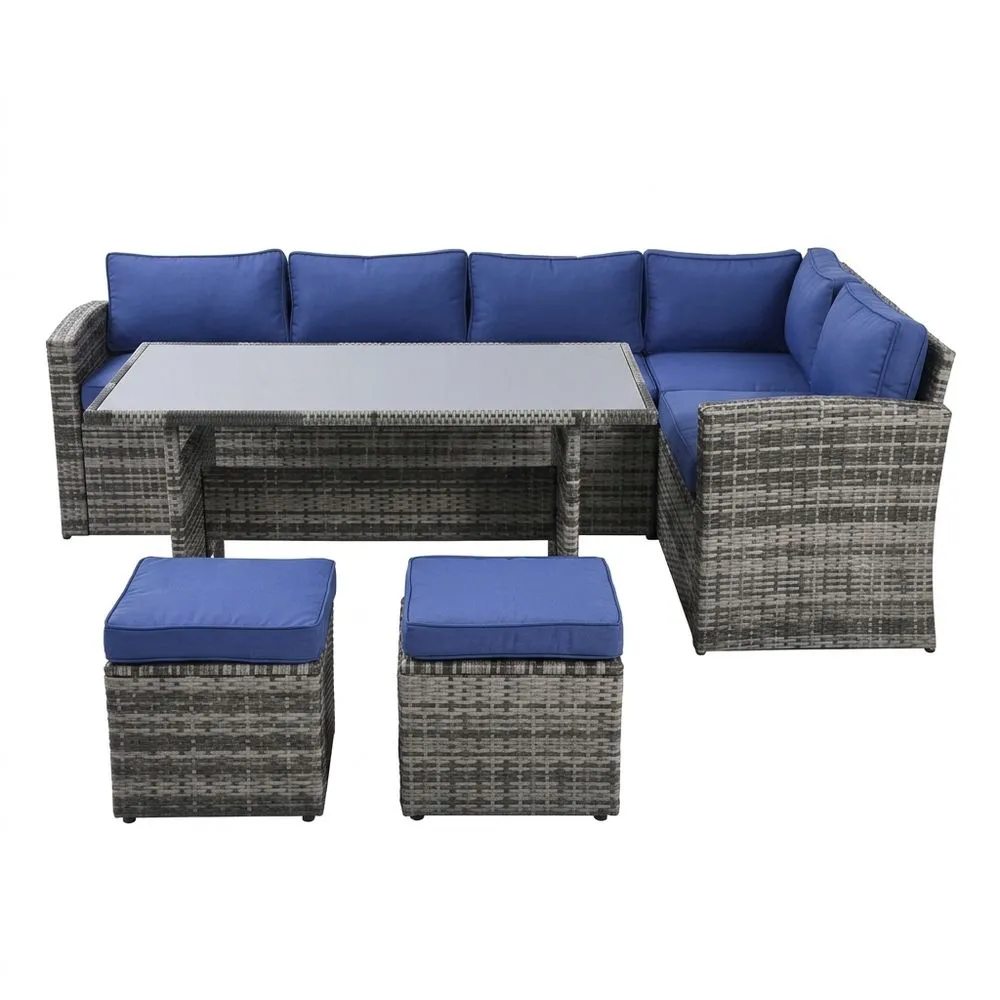 Set divano angolare da giardino in rattan con cuscini blu e tavolo in vetro