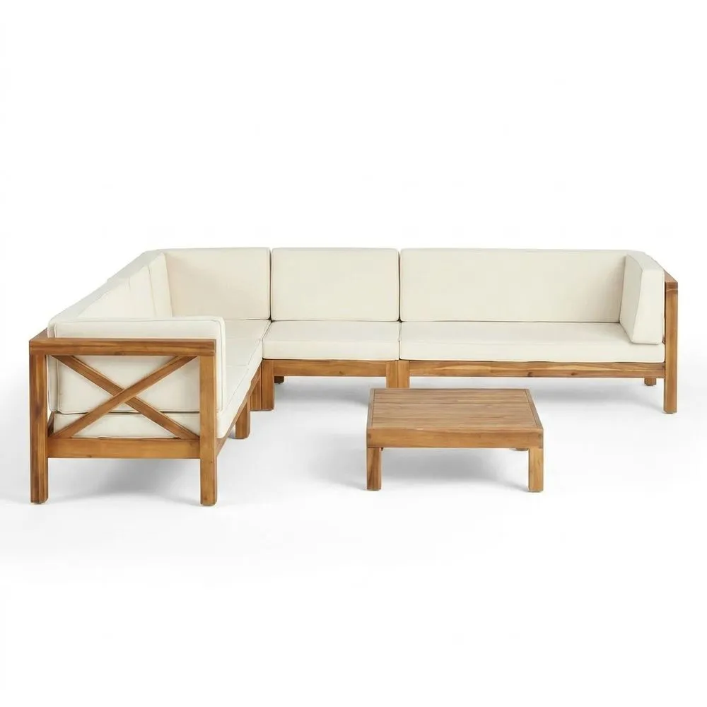 Divano angolare in teak con tavolino e cuscini di seduta beige