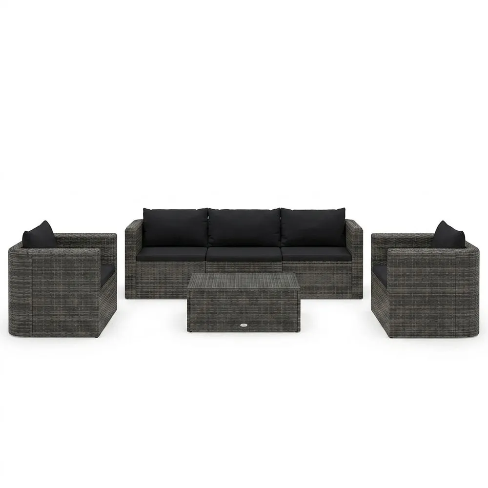 Conjunto de sofás de ratán para jardín con cojines negros.