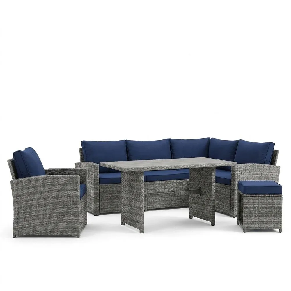 Conjunto de jardín de ratán artificial con cojines azul oscuro.