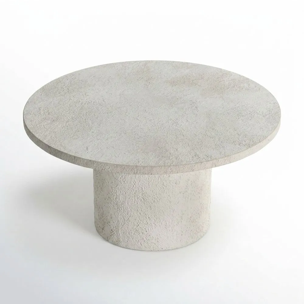 Una mesa de centro redonda de color gris cemento.