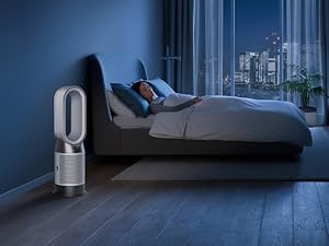 Person sleeping in dark room while the purifier quietly purifies the room