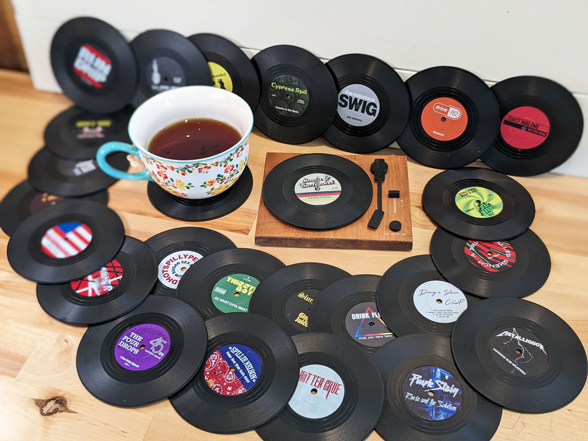Drink resting on a record coaster beside holder