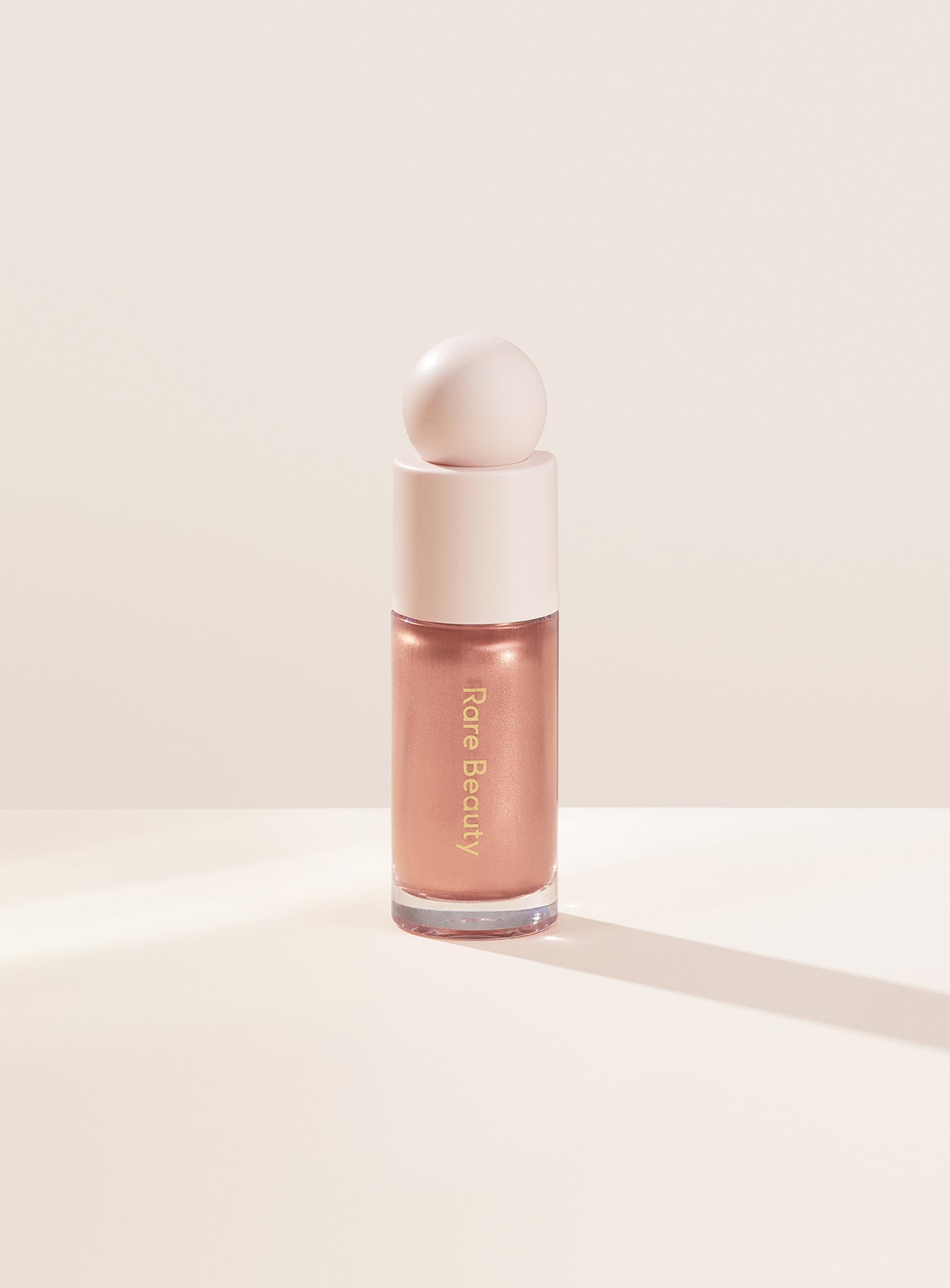 Transcend| Rare Beauty's Positive Light Liquid Luminizer in the rose gold shade "Transcend."