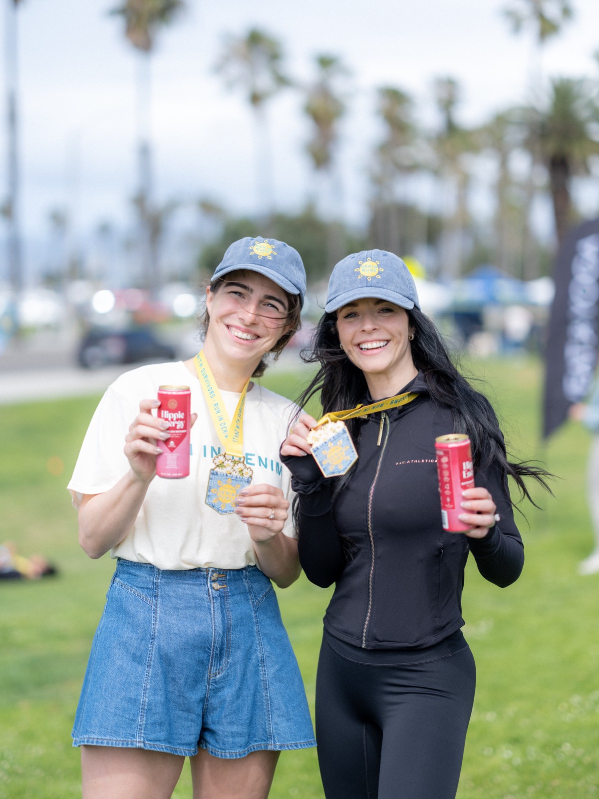 Two Denim Run participants with medals and Hippie Energy cans